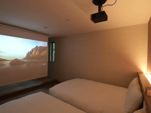 a bedroom with a projection screen on the wall at Rakuten STAY VILLA Nikko in Nikko