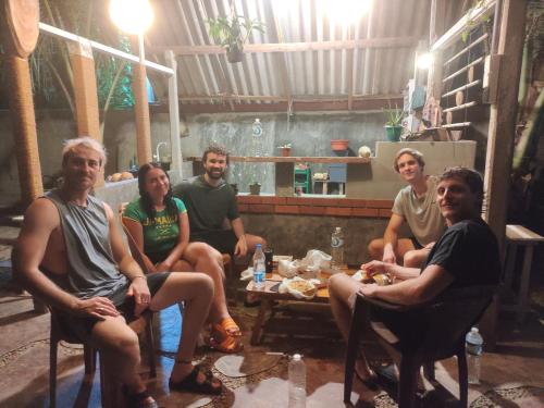 a group of people sitting around a table at Galle Wonvil Apartment in Galle