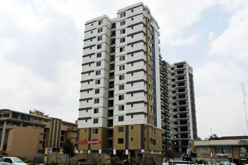 a tall white building in a city at 2 Bedroom in Kilimani Ngong Rd in Nairobi