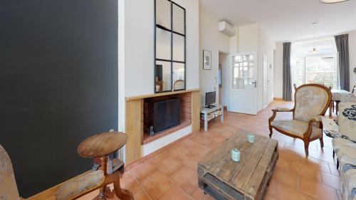 a living room with a couch and a fireplace at Domaine Paul Huc in Fabrezan