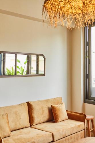 a living room with a couch and a window at Mosaics Athens Boutique Apartments in Athens