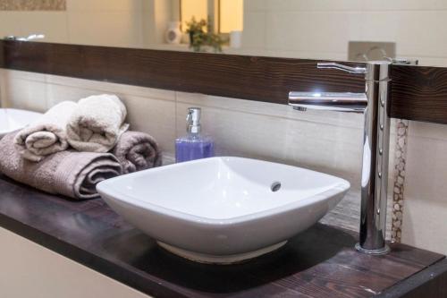 a bathroom with a white sink on a counter at Upper Valley Mansions, No.25 in Cospicua