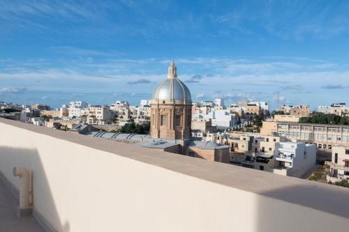 a view of a city from the roof of a building at Upper Valley Mansions, No.25 in Cospicua