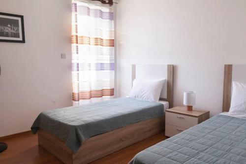 a bedroom with two beds and a window at Upper Valley Mansions, No.25 in Cospicua