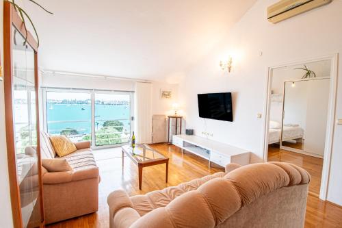 a living room with a couch and a television at Apartment Umag Center Istria Croatia in Umag