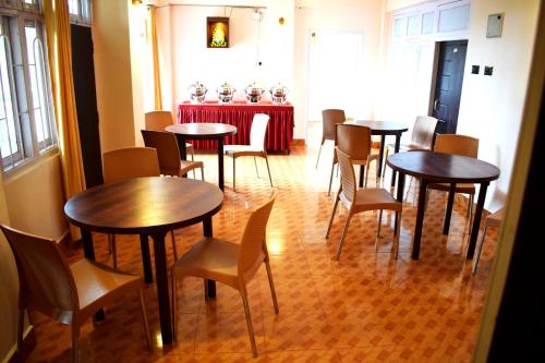 a group of tables and chairs in a room at LILY GUEST HOUSE in Shillong