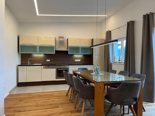 a kitchen and dining room with a table and chairs at Ferienwohnung Jäger Veronika in Altenmarkt im Pongau