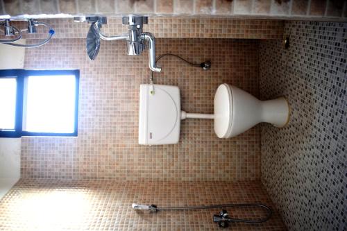 a shower in a tiled bathroom with a toilet at LILY GUEST HOUSE in Shillong
