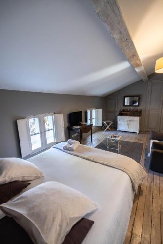 a large bedroom with a large white bed in a room at Chambres d hôtes du Castell de Blés in Saint-Génis