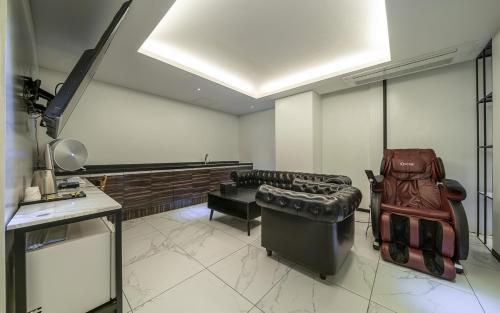 a living room with a couch and a stage at Cacao Hotel in Incheon