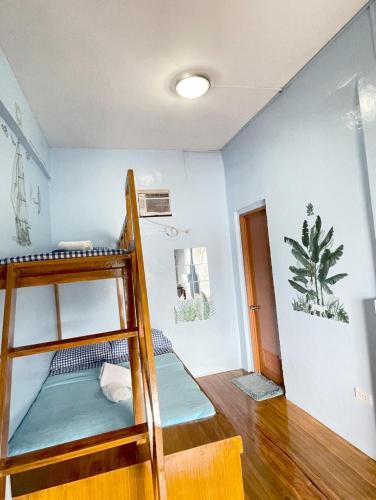 a room with two bunk beds in a room at Camiguin Blue Lagoon Cottages in Mahinog