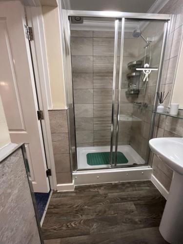 a shower with a glass door in a bathroom at Rockmount Court in Bournemouth