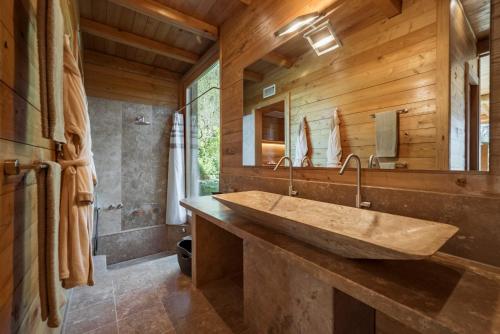 a bathroom with a large sink and a mirror at Boutique Hotel Poggio ai Santi - Adults Only in San Vincenzo