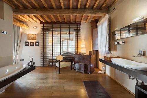 a bathroom with two sinks and a desk at Boutique Hotel Poggio ai Santi - Adults Only in San Vincenzo
