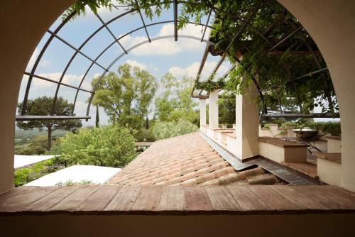an arched entry way to a house with a glass roof at Boutique Hotel Poggio ai Santi - Adults Only in San Vincenzo