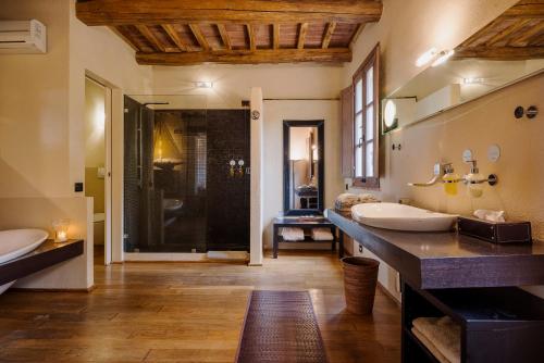 a large bathroom with two sinks and a shower at Boutique Hotel Poggio ai Santi - Adults Only in San Vincenzo