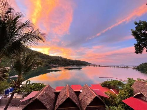 a view of a river with a rainbow in the sky at Camiguin Blue Lagoon Cottages in Mahinog