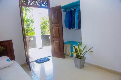 a room with a bed and a glass door at Seyoo Villa in Ahangama