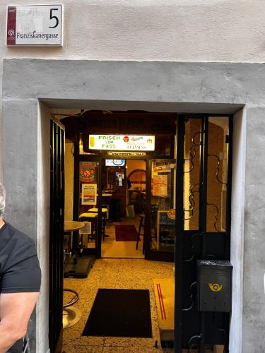 an entrance to a restaurant with a door open at Private room in innerstadt graz in Graz