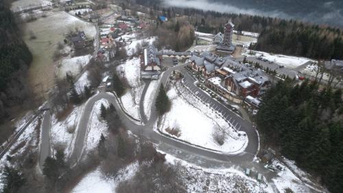 an aerial view of a roller coaster in the snow at Hotel Beskidzki Raj Medical SPA in Stryszawa