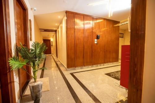 un pasillo con paneles de madera y una maceta en Sun City Hotel, en El Cairo