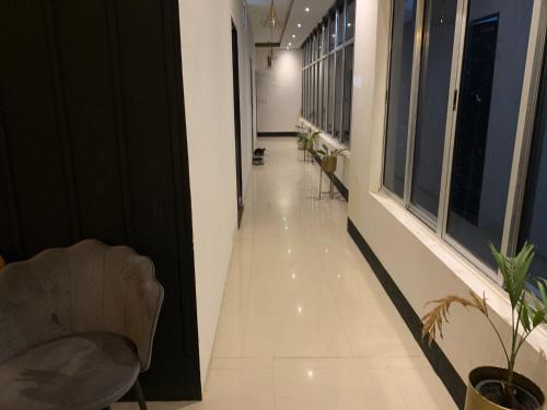 an empty hallway with chairs and a couch in a building at Brookside B&B in Dibrugarh