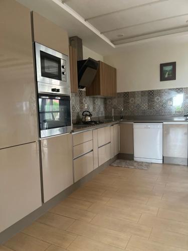 een keuken met roestvrijstalen apparatuur en witte kasten bij Appartement in Tamaris