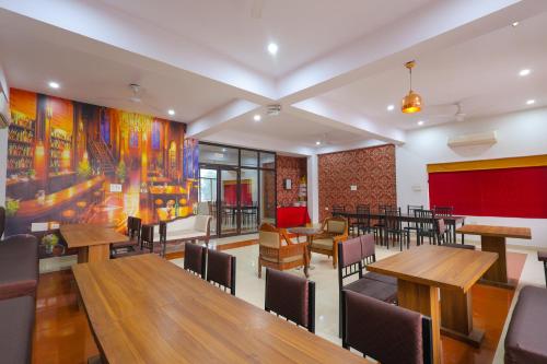 a dining room with wooden tables and chairs at Taj Classic Agra in Agra