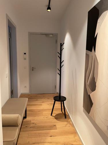 a room with a chair and a painting on the wall at My Marina Apartment mit Pool und Sauna am See in Bad Saarow