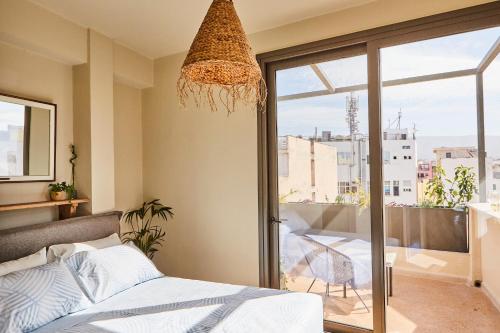 a bedroom with a bed and a balcony at Mosaics Athens Boutique Apartments in Athens