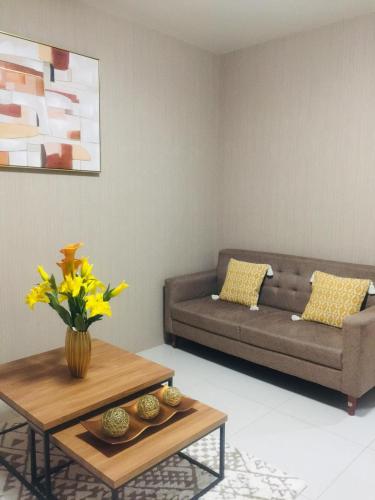 a living room with a couch and a table at Brenthill Condominium in Baguio