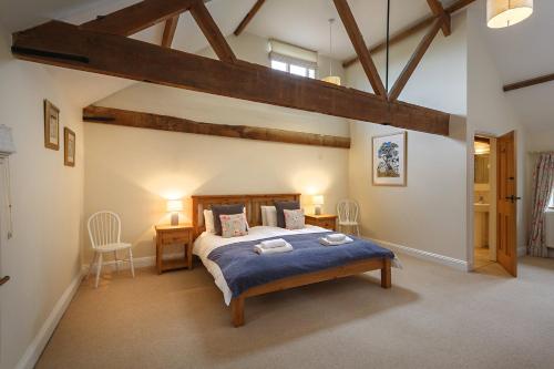 a bedroom with a large bed in a room at Kings Beck Barn in Norwich