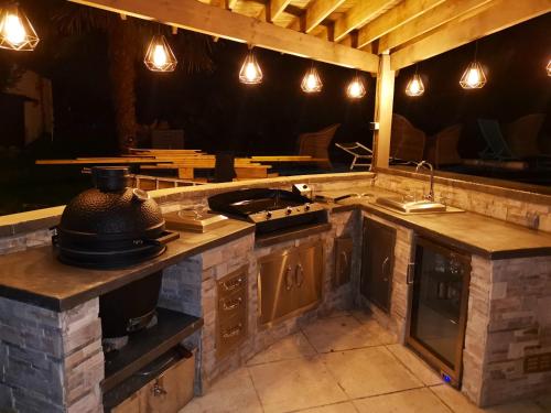 an outdoor kitchen with a stove and a sink at Villa de 4 chambres avec piscine privee et wifi a Maule in Maule