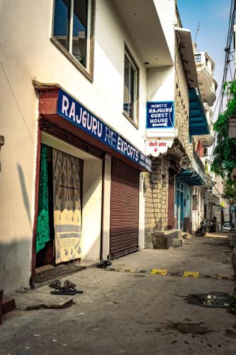a building with a sign on the side of a street at Rajguru guest house in Pushkar