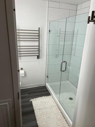 a bathroom with a glass shower with a rug at YotelPAD Park City Unit #432 in Park City