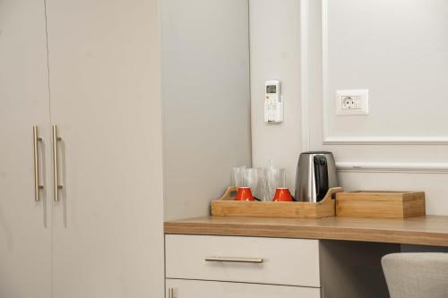 a kitchen with a counter with a wooden cutting board at Hotel Zamca Suceava in Suceava