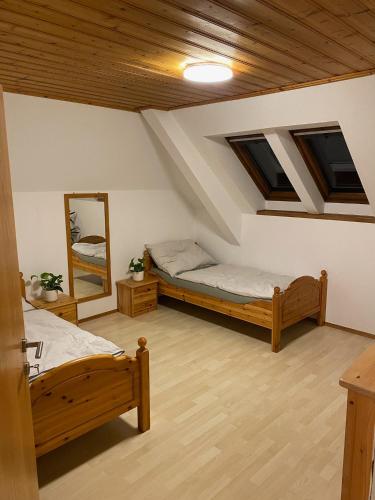 a attic room with two beds and a mirror at Große Wohnung mit Altstadtnähe 