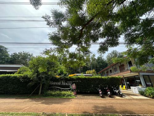 two motorcycles are parked in front of a house at Hanoii House in Ko Mak