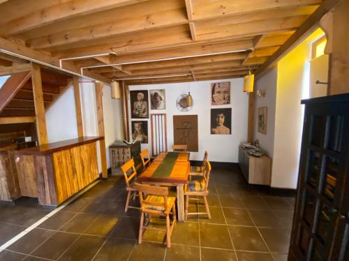 a dining room with a wooden table and chairs at Hostal Tatul in Diaguita