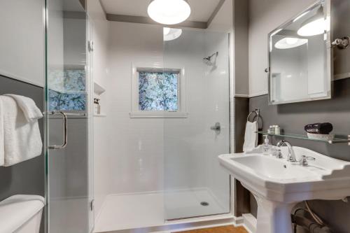 a bathroom with a shower and a sink at Cozy Eureka Springs Cottage, Walk to Dtwn! in Eureka Springs
