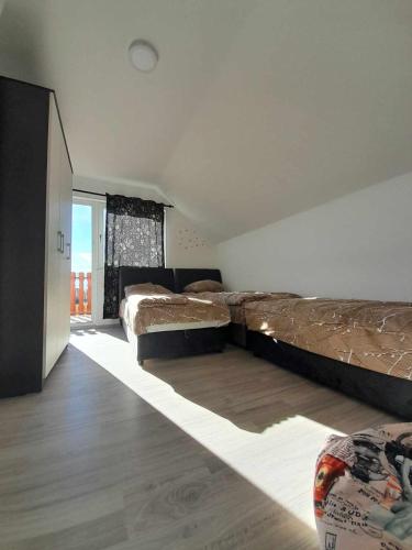 a large bedroom with two beds and a window at L&L in Sarajevo