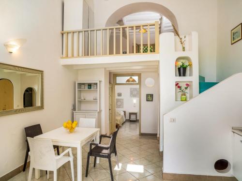 a kitchen and dining room with a table and chairs at Villa Ginestra sulla spiaggia di Stromboli in Stromboli