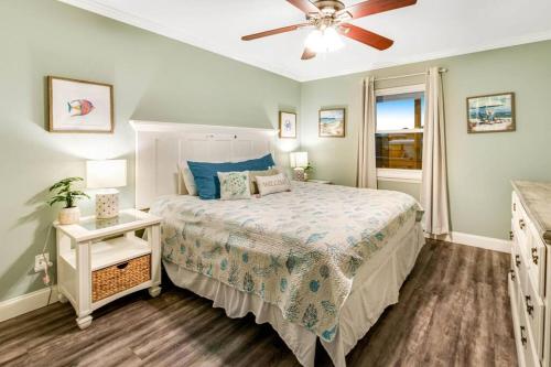 a bedroom with a bed and a ceiling fan at 2-BDRM Across From Beach 10 min Walk to Hangout! in Gulf Shores
