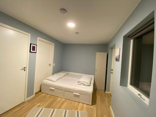 a small bedroom with a bed and a window at Your Dream Studio in Bergen in Bergen