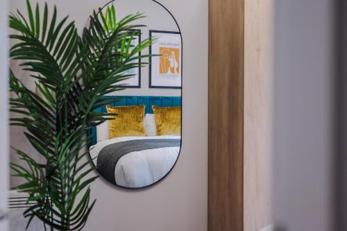 a mirror on a wall next to a bed at Host & Stay - Ropewalks Quarters in Liverpool
