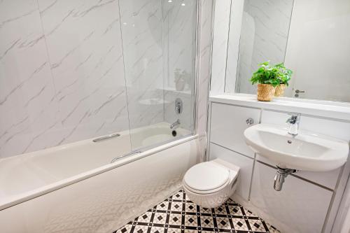 a bathroom with a sink and a toilet and a bath tub at Host & Stay - Ropewalks Quarters in Liverpool
