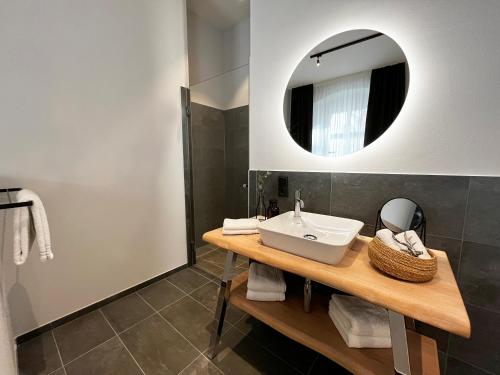 a bathroom with a sink and a mirror at Mariandl am Berg in Amberg