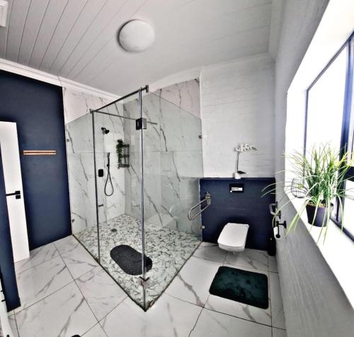 baño con ducha y puerta de cristal en SkatKus Eco Estate, en Stilbaai-Wes