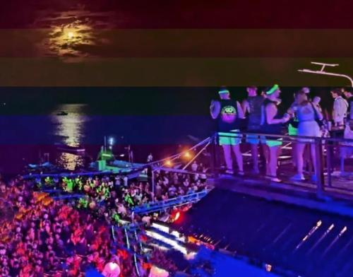 a crowd of people standing on a balcony at a concert at Full Moon Central Party Hotel in Koh Phangan