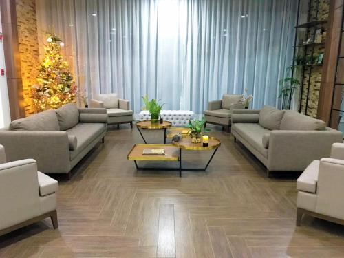 a living room with couches and a christmas tree at Brenthill Condominium in Baguio